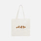 A white canvas tote bag featuring a printed design of three brown gingerbread dachshunds with decorative icing details.