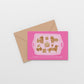 Pink gingerbread dogs on tray greeting card with brown envelope