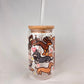 Glass tumbler with wooden lid and straw featuring illustrations of wiener dogs